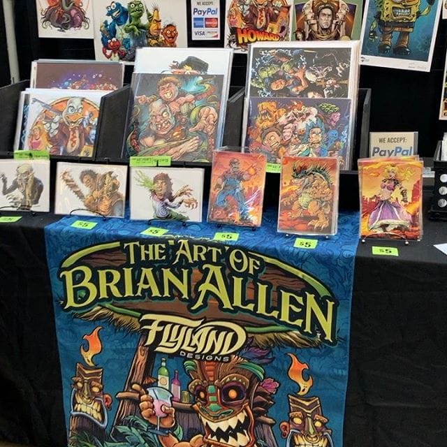 Just got setup at @replayfx in Pittsburgh- it’s hot as hell in here but I think it’s going to be a good show. This is my home for the next four days. Slim Jim’s and Mountain Dew will carry me through it. Finally getting my booth the way I want it. If you see anything you want please message me.#pinballart #arcadeart #retroart #conventionartist