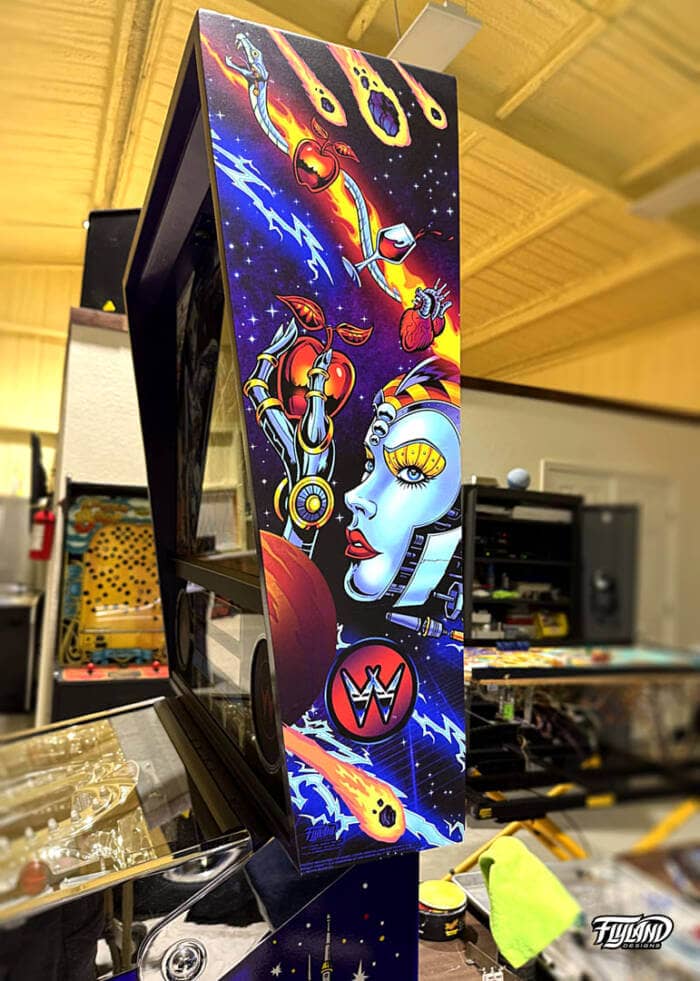 Bride of Pinbot Vinyl wrap for Pinball Machines artwork by Brian Allen. An illsutration of an outerspace drawing with a large woman robot with astroids, and planeits.