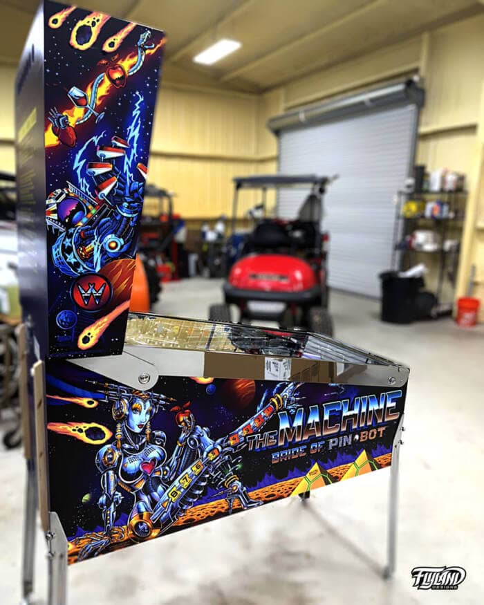 Bride of Pinbot Vinyl wrap for Pinball Machines artwork by Brian Allen. An illsutration of an outerspace drawing with a large woman robot with astroids, and planeits.