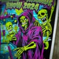 Colorful illustration of a grim reaper and skeletons playing pinball in a graveyard