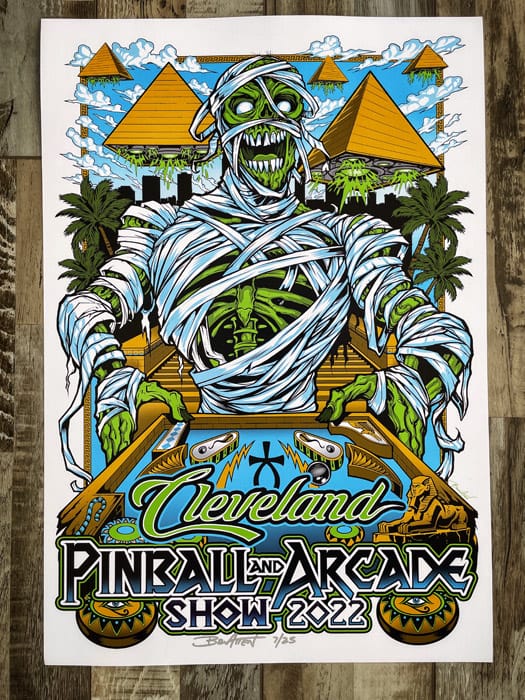 cleveland pinball and arcade show poster of a skeleton mummy playing pinball with pyramid spaceships flying in the sky