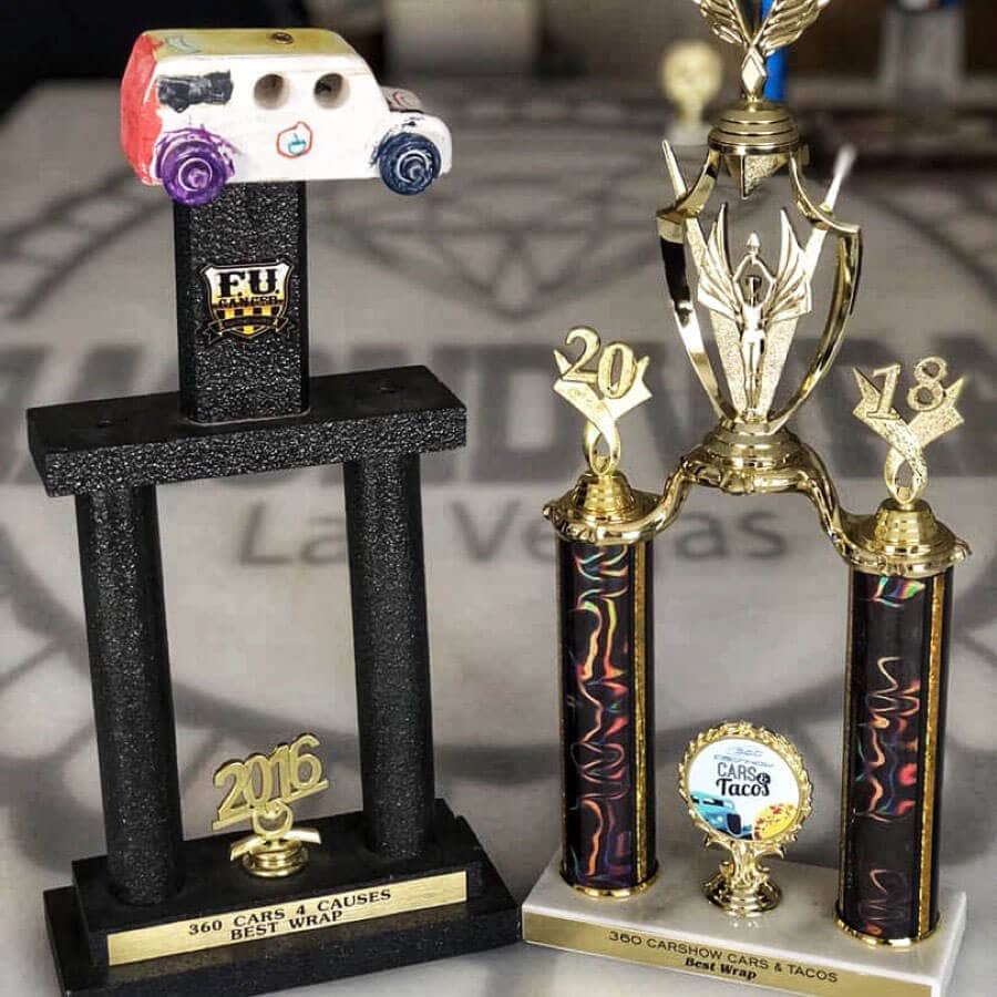 Trophies awarded to the car wearing the vehicle wrap designed by Flyland Designs