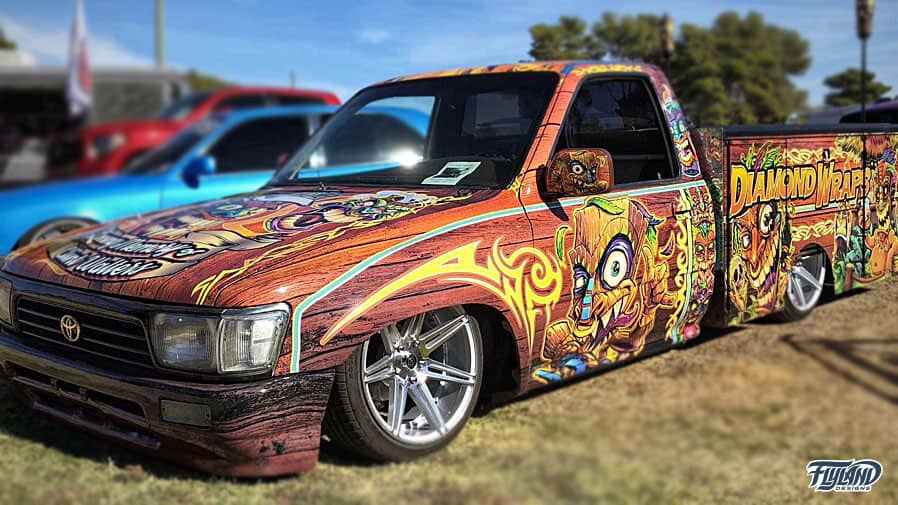 A vehicle wrap showcasing many different tropical tiki characters. The text reads "Diamond Wraps"