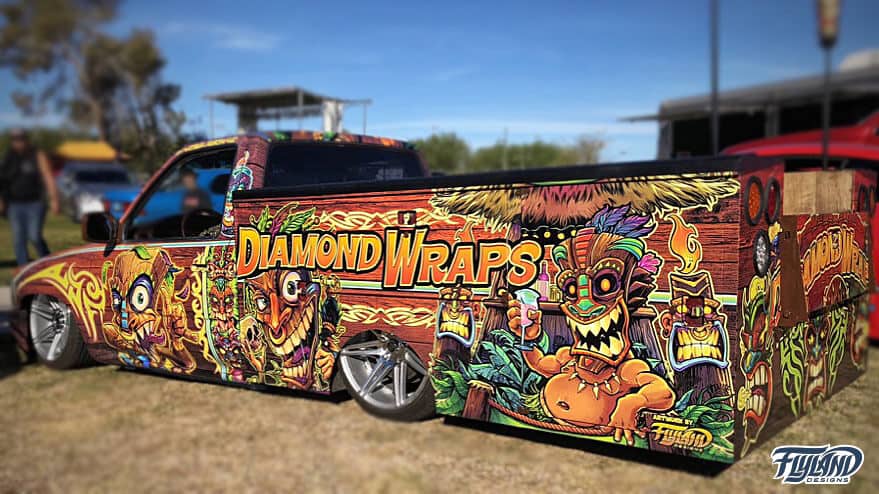 A pickup truck with a graphic vehicle wrap with lots of cool tikis. Cool tiki vehicle wrap for trcuk.