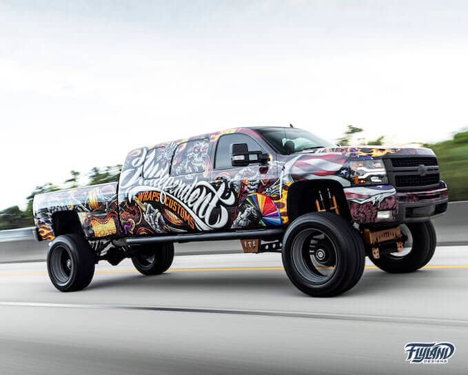 A vehicle wrap decorating a truck with Skull and wings, and skeleton with wrapping tools and materials drawn for a truck vehicle vinyl wrap