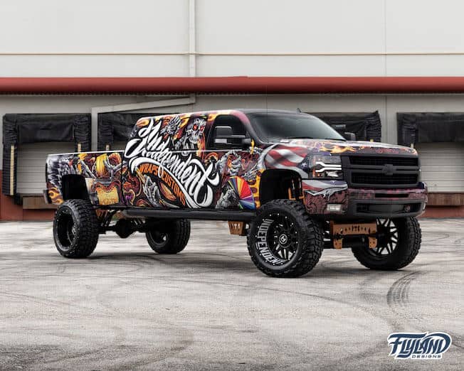 A vehicle wrap decorating a truck with Skull and wings, and skeleton with wrapping tools and materials drawn for a truck vehicle vinyl wrap