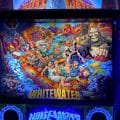 Alternate pinball artwork of Williams Whitewater that features the Creature from the Black Lagoon, the woman in the white dress from Attack From Mars, Dr. Dude, and a cameo from the No Good Gofers varmint as well as some outdoor movies, like Deliverance, and “The Great Outdoors.”