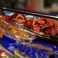 Alternate pinball artwork of Williams Whitewater that features the Creature from the Black Lagoon, the woman in the white dress from Attack From Mars, Dr. Dude, and a cameo from the No Good Gofers varmint as well as some outdoor movies, like Deliverance, and “The Great Outdoors.”